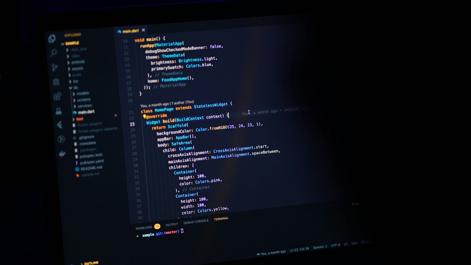 A laptop screen showing lines of code in the dark