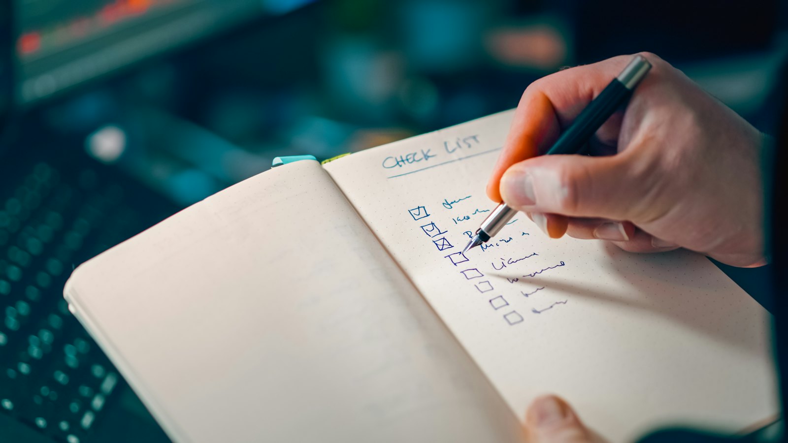 Writing a checklist in a notebook