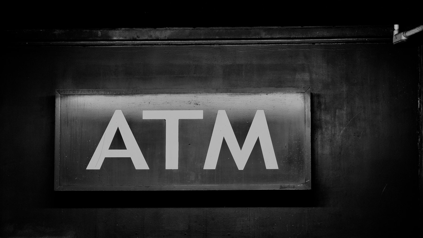 An ATM sign above a cash machine