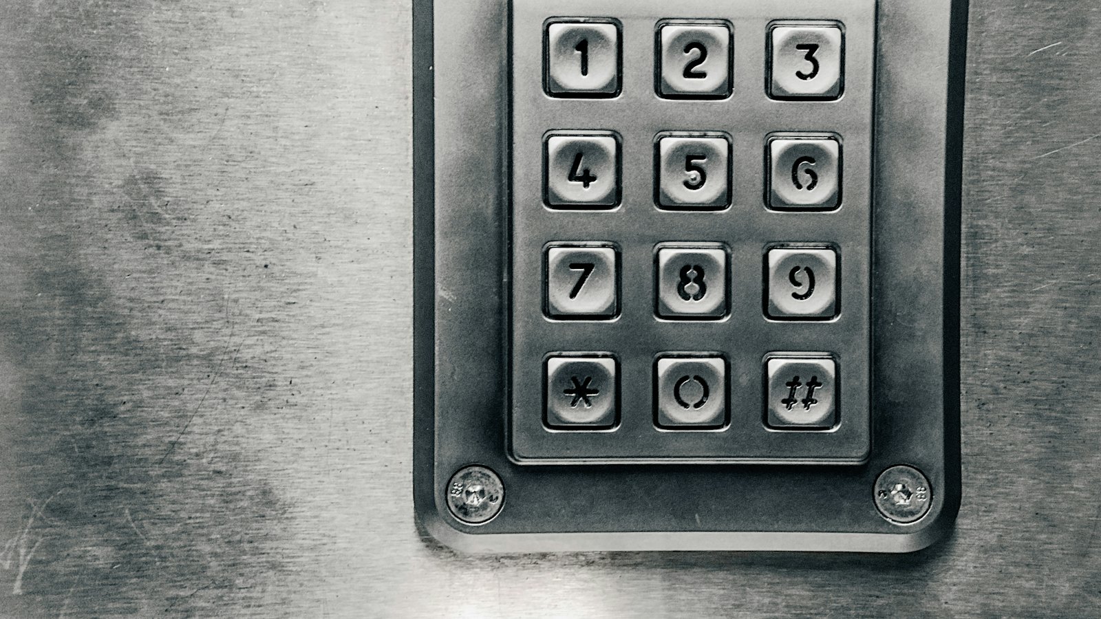 A metal keypad with numbered buttons