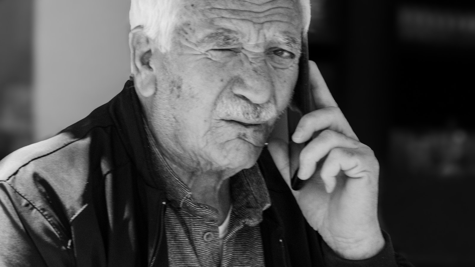An older man on a phone call