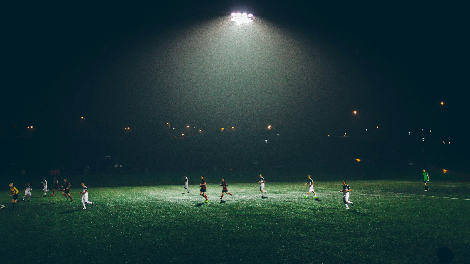 A floodlit football match at night