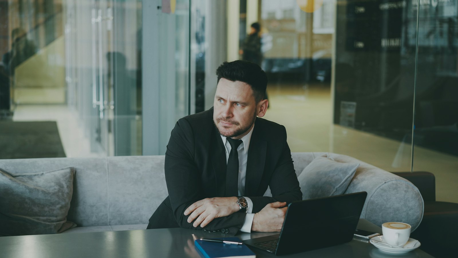 A business owner sitting with a laptop in an office lounge