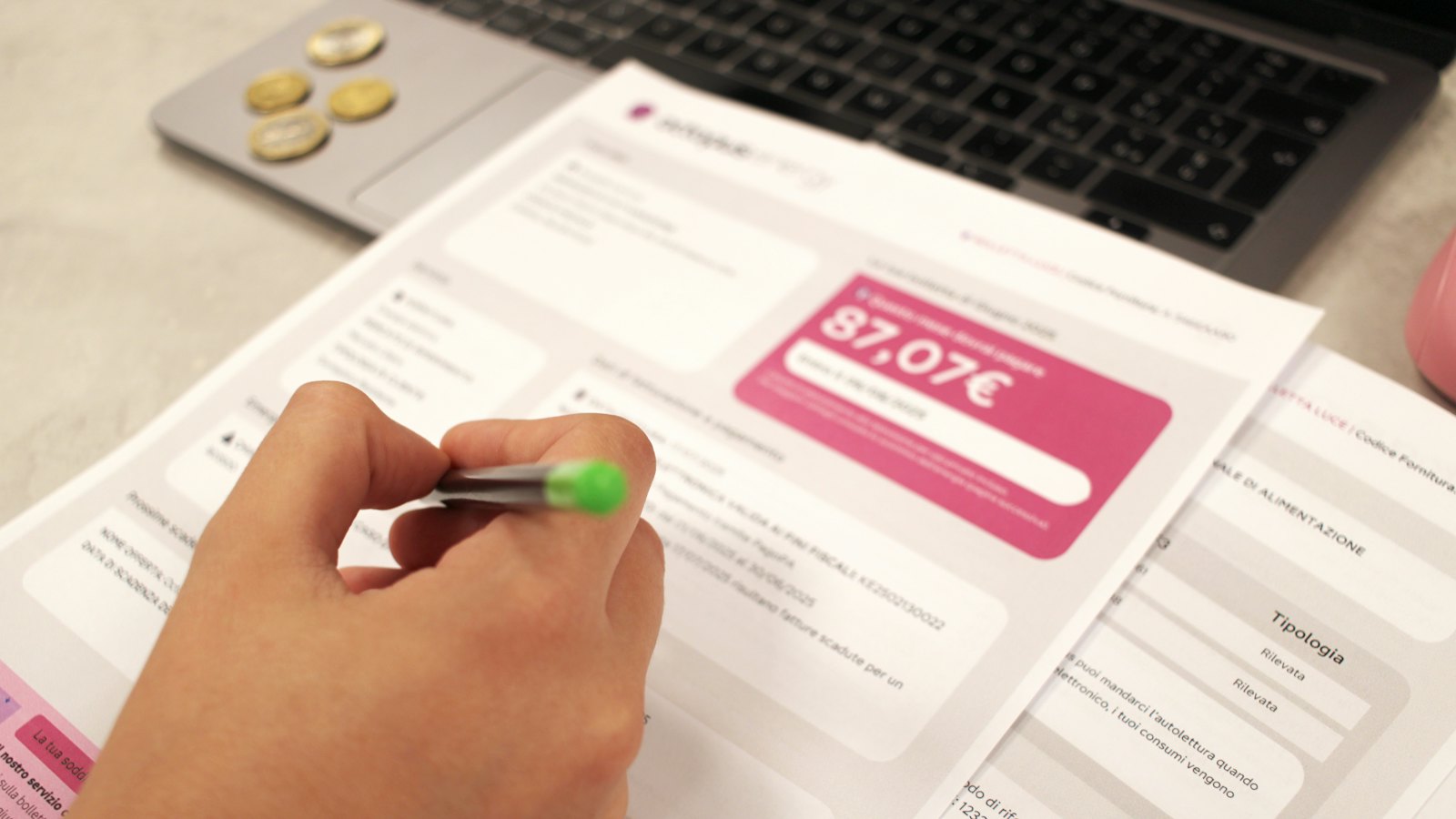 A person reviewing a printed bill with a pen
