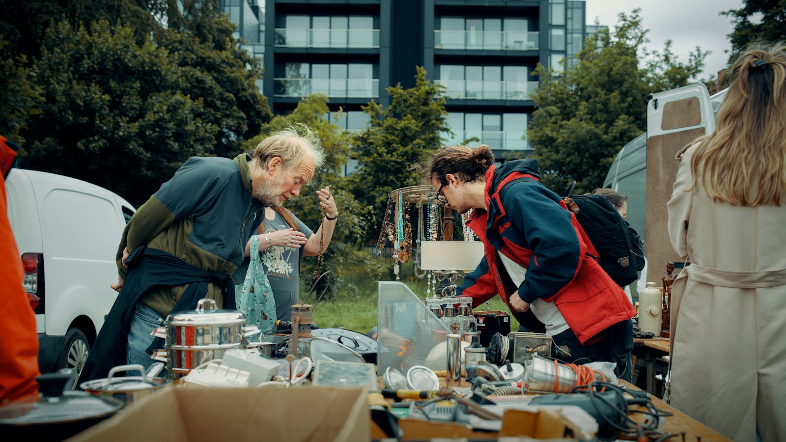 People browsing goods at an outdoor market stall
