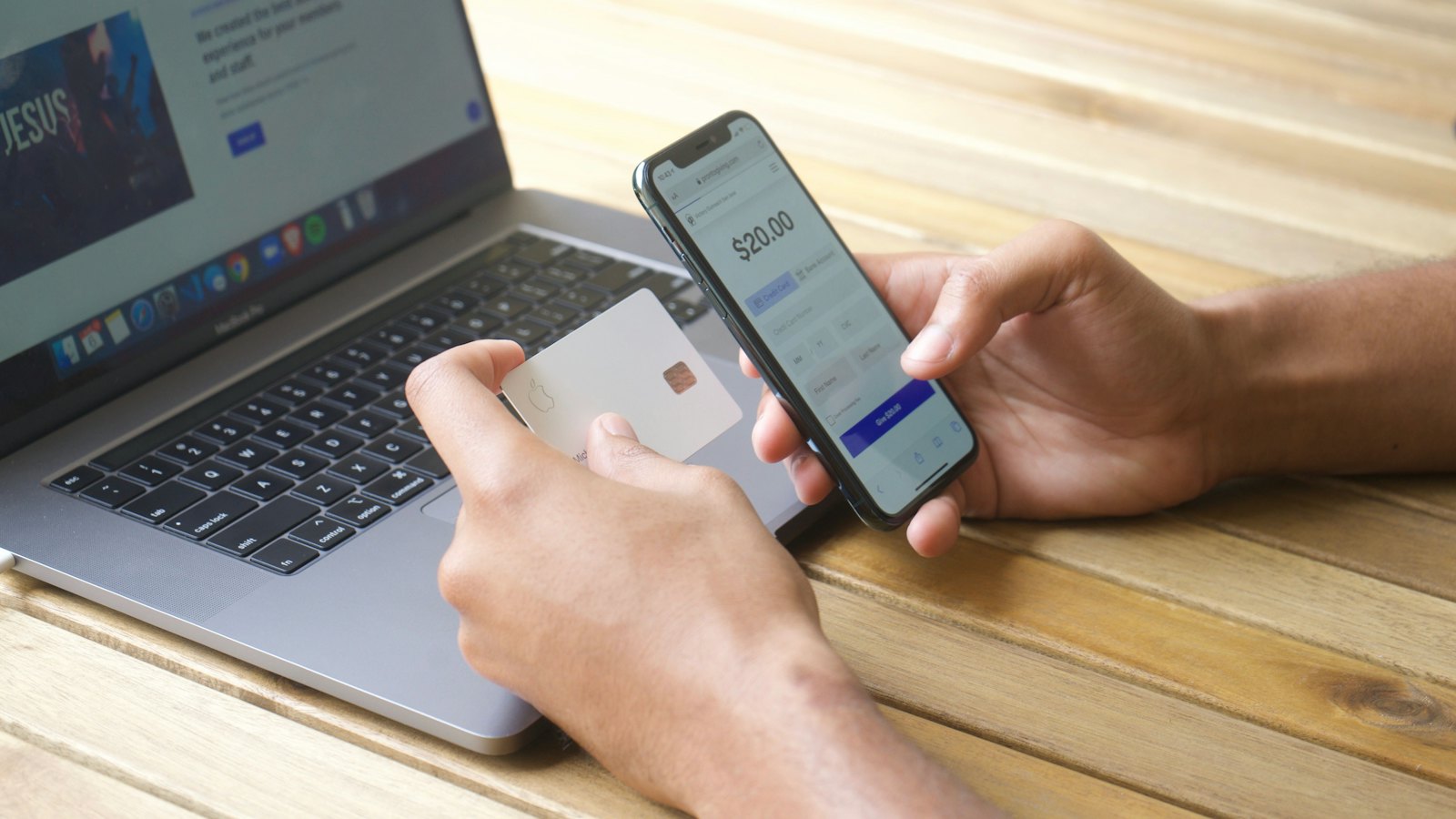 A person shopping online with a card and a phone