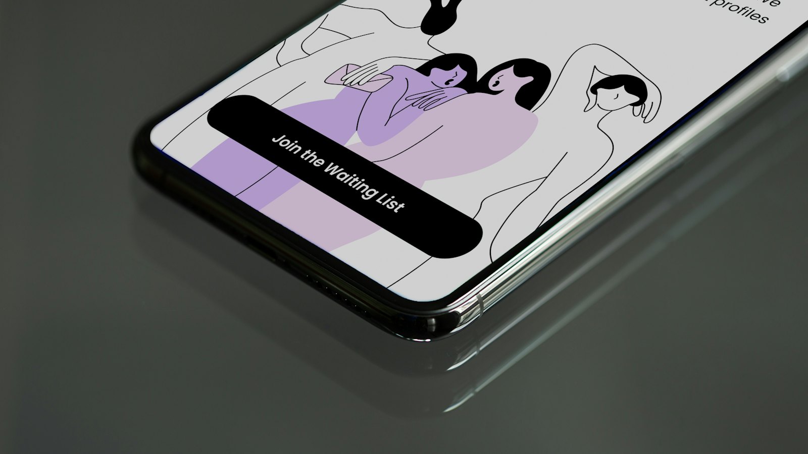 A phone lying on a dark surface showing an app sign-up screen
