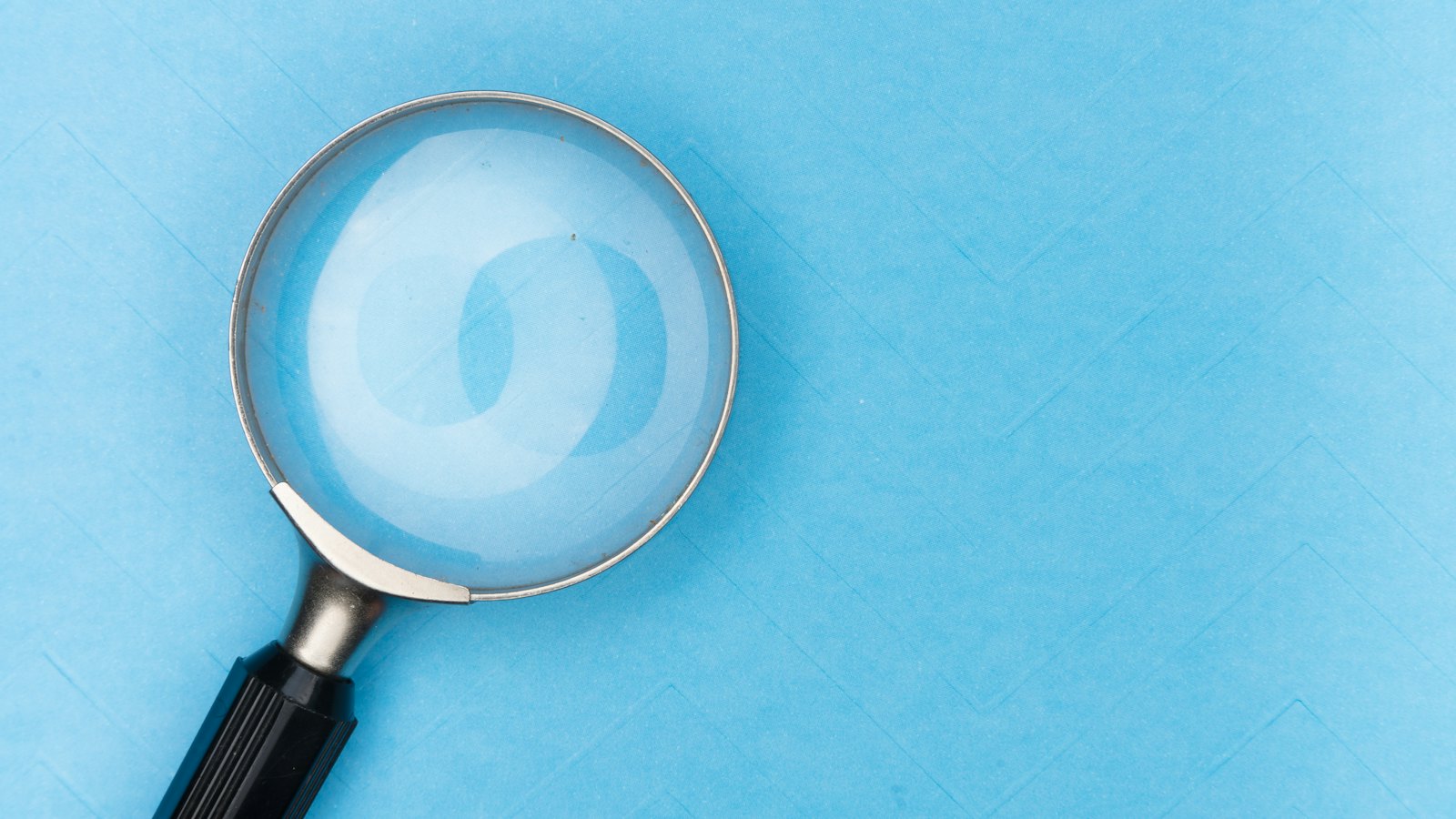 A magnifying glass on a blue background