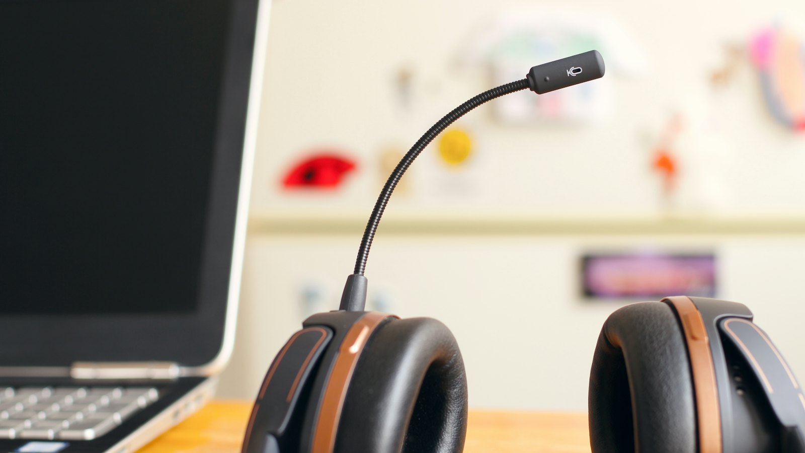 A headset beside a laptop