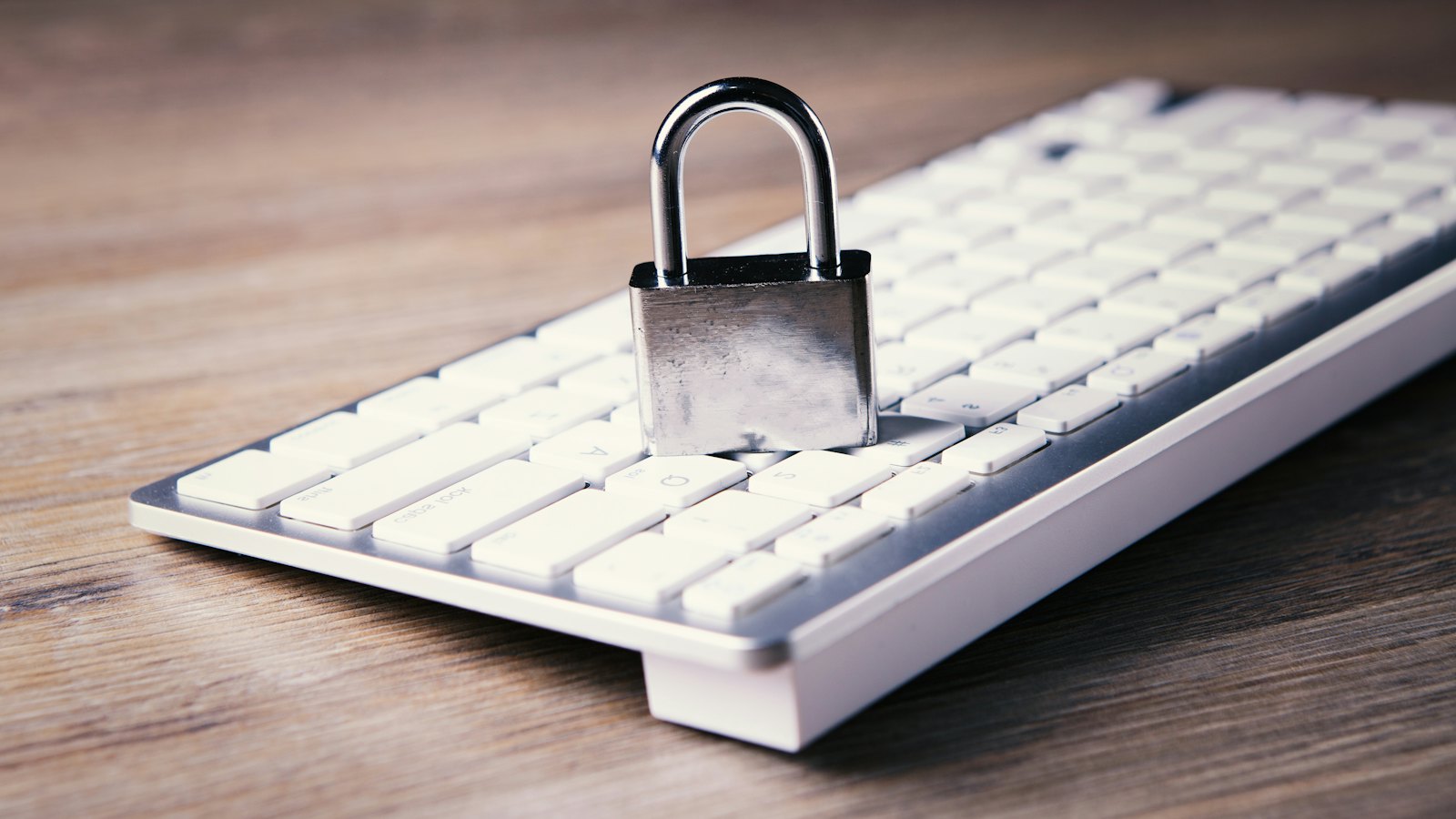 A padlock resting on a white keyboard