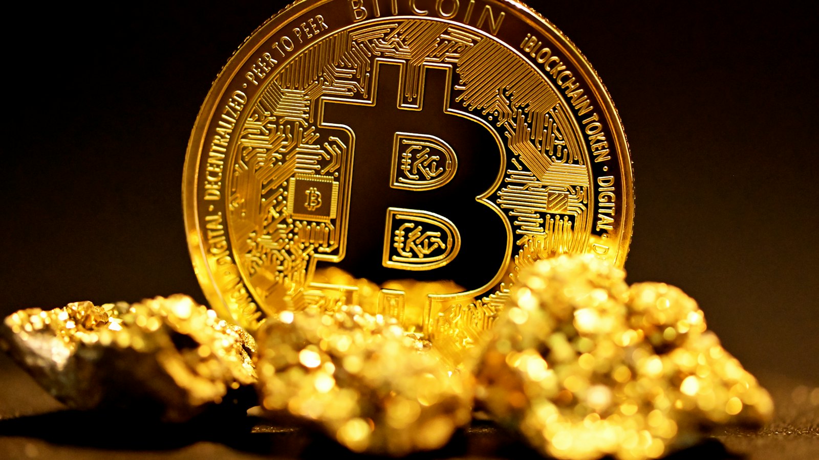 A gold bitcoin coin on gold nuggets