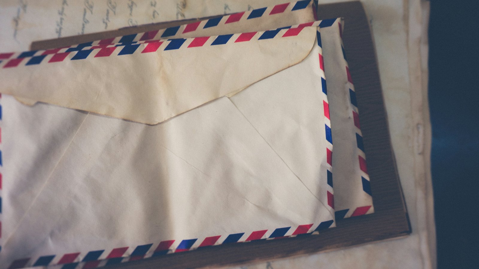 A stack of airmail envelopes on a table