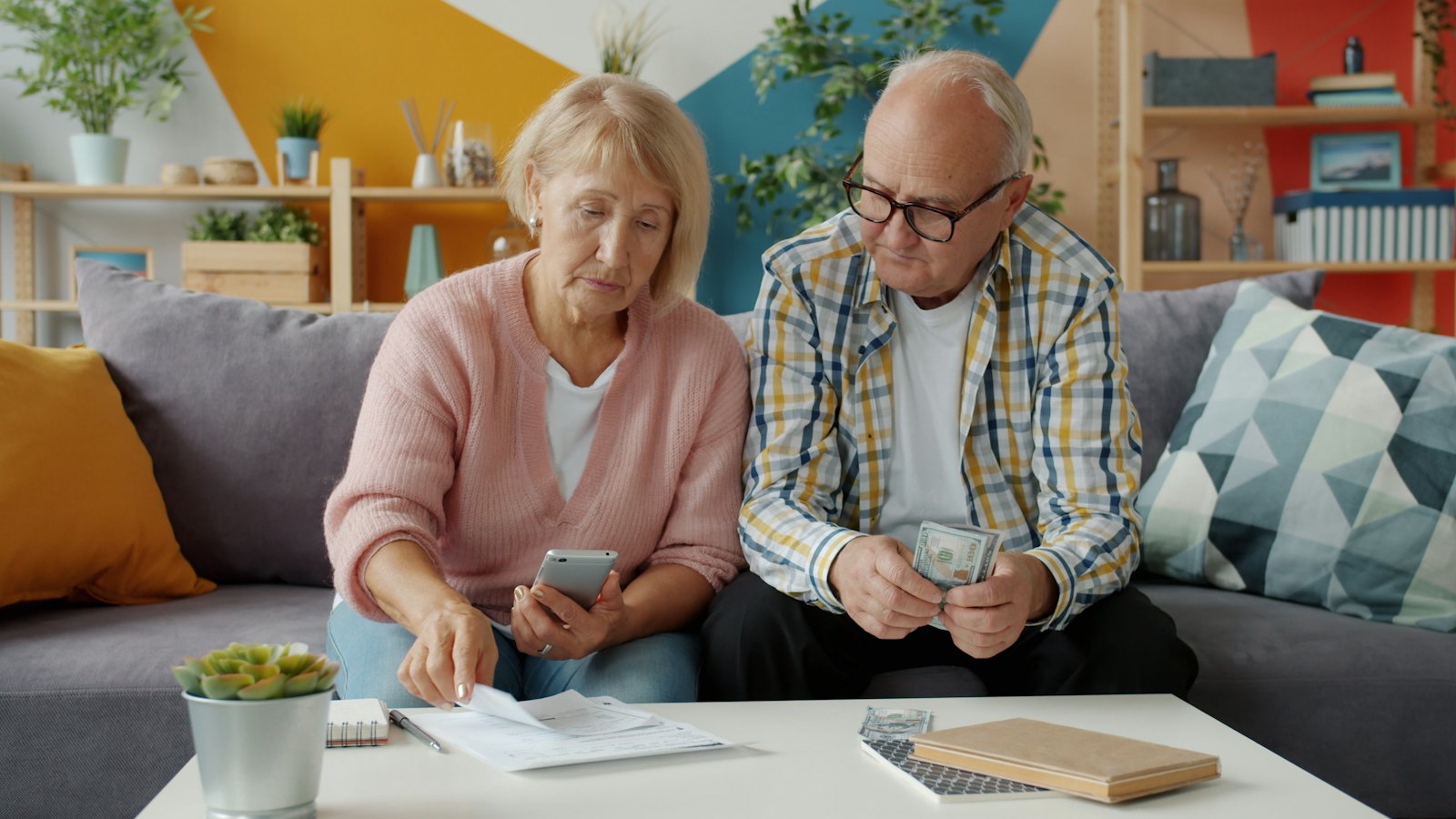 An older couple checking bills together