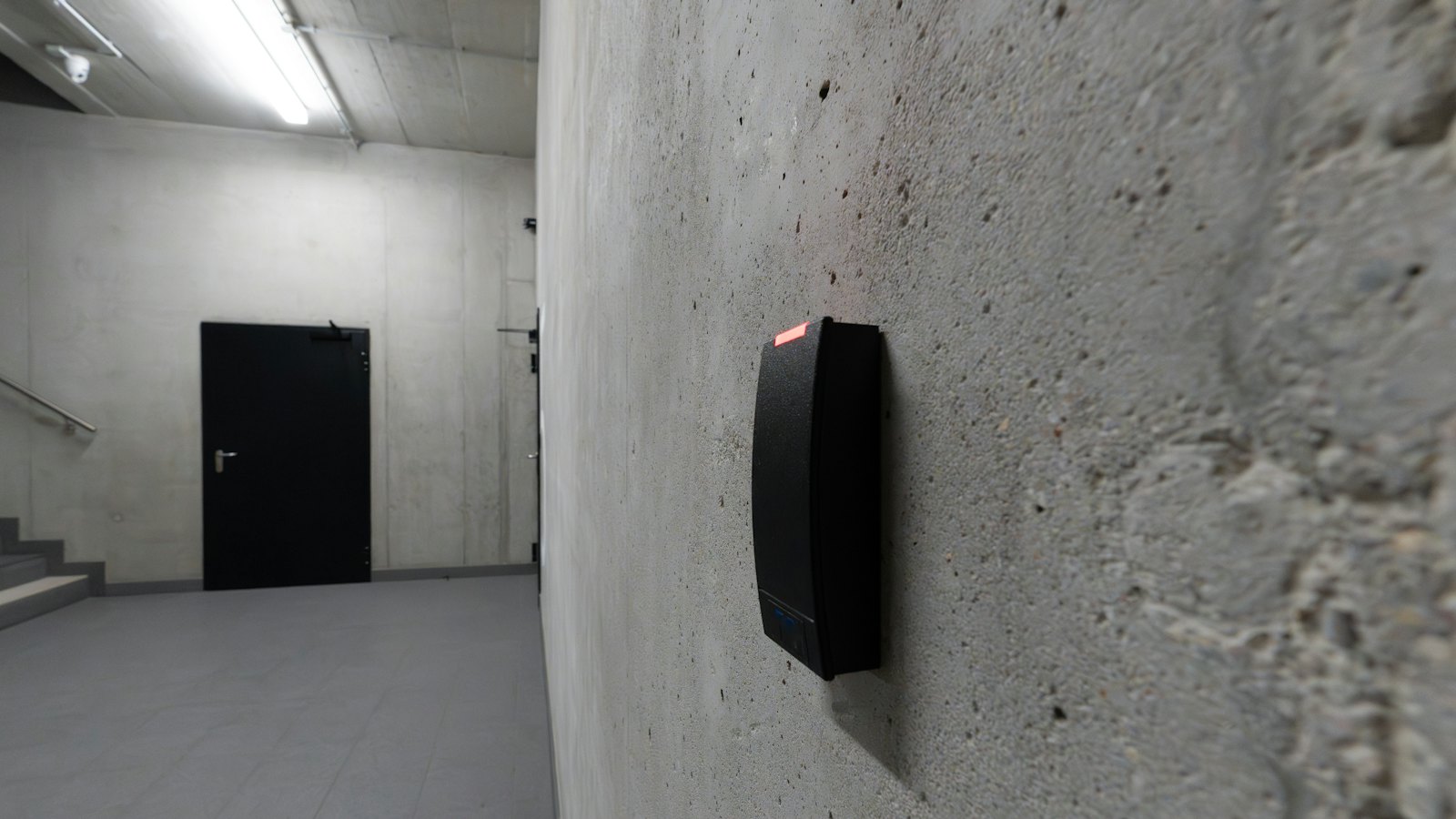 A card reader beside a door in a corridor