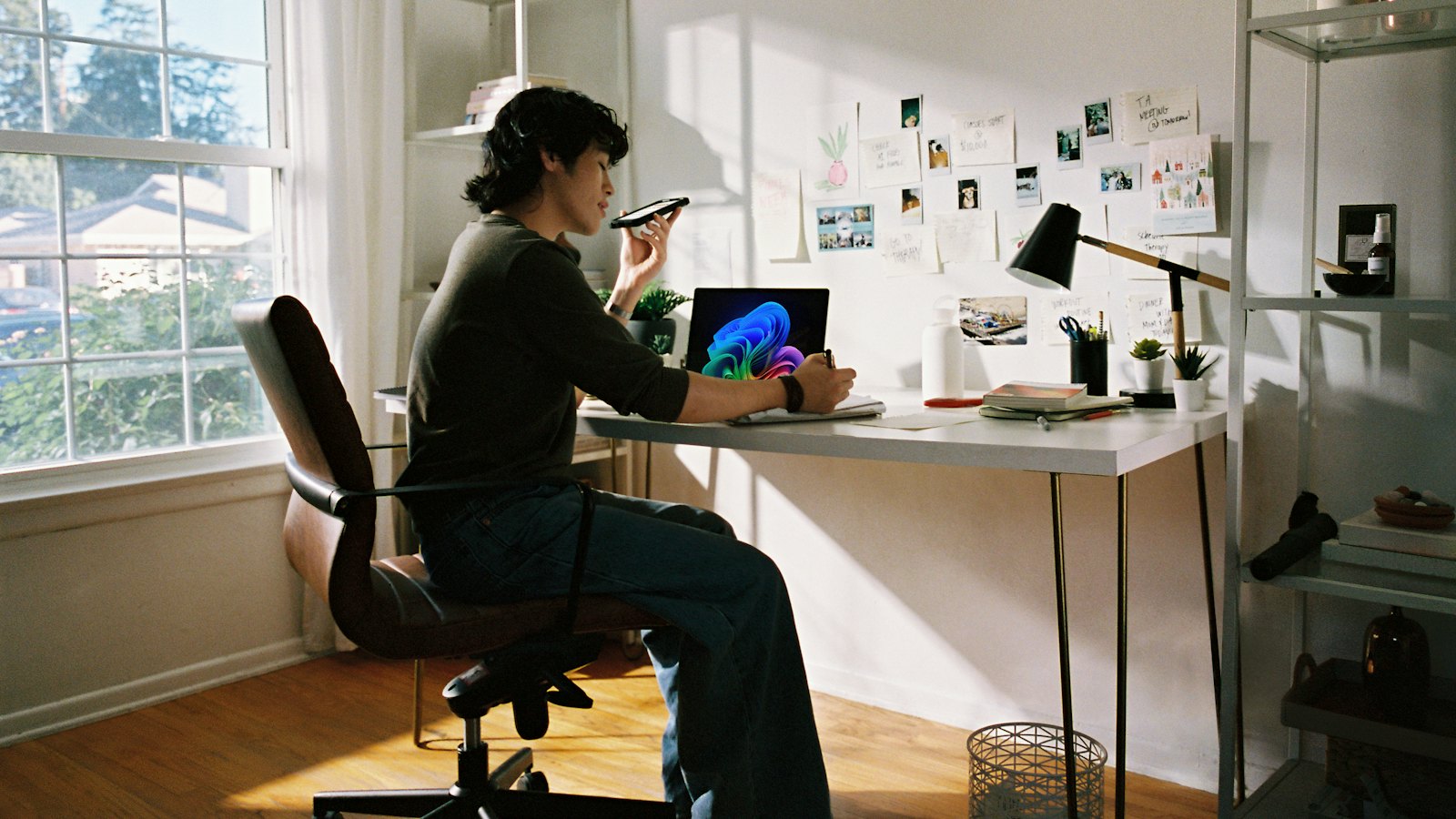 A woman sending a voice message at her desk at home