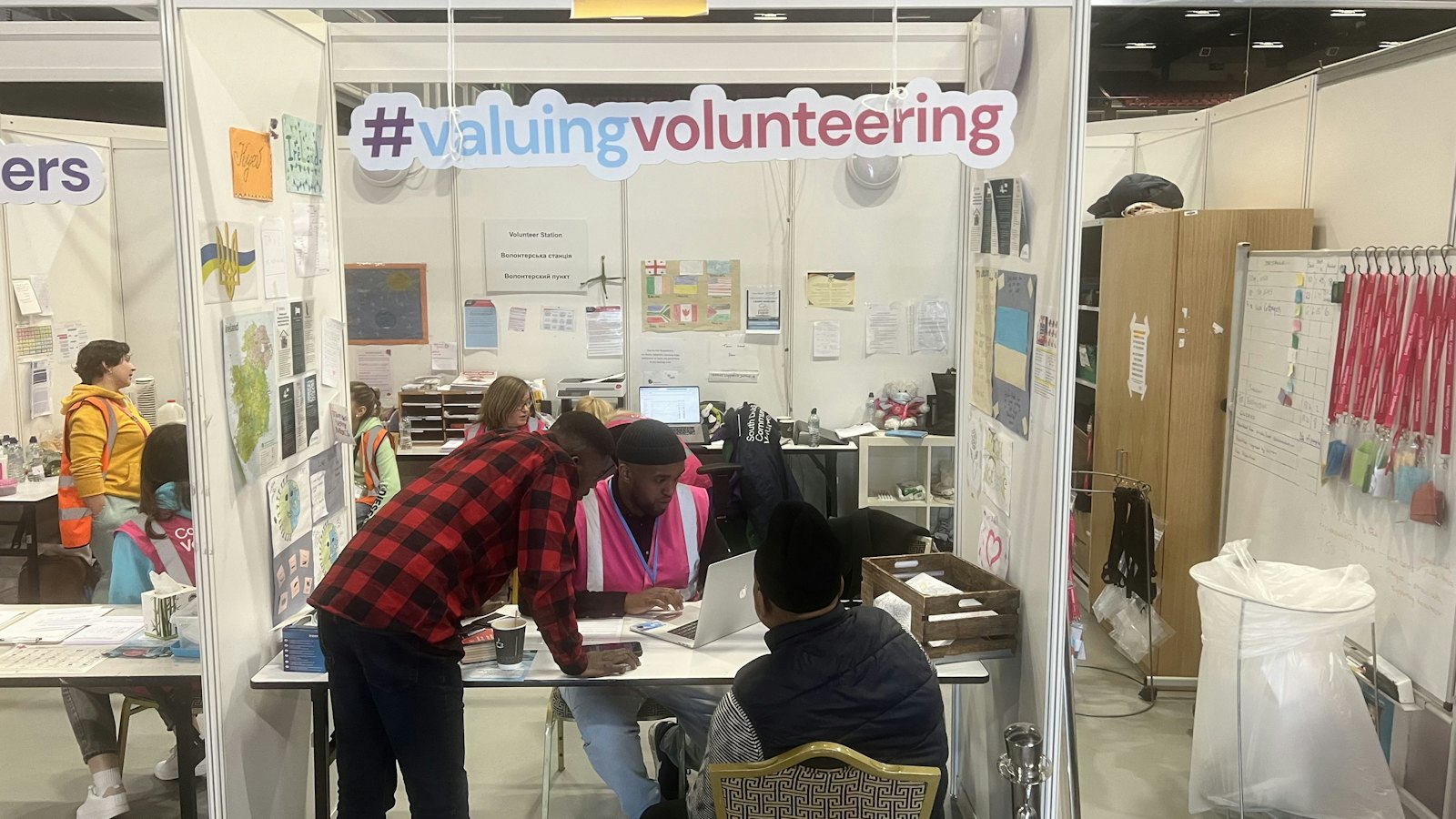 People working at desks in a busy community office