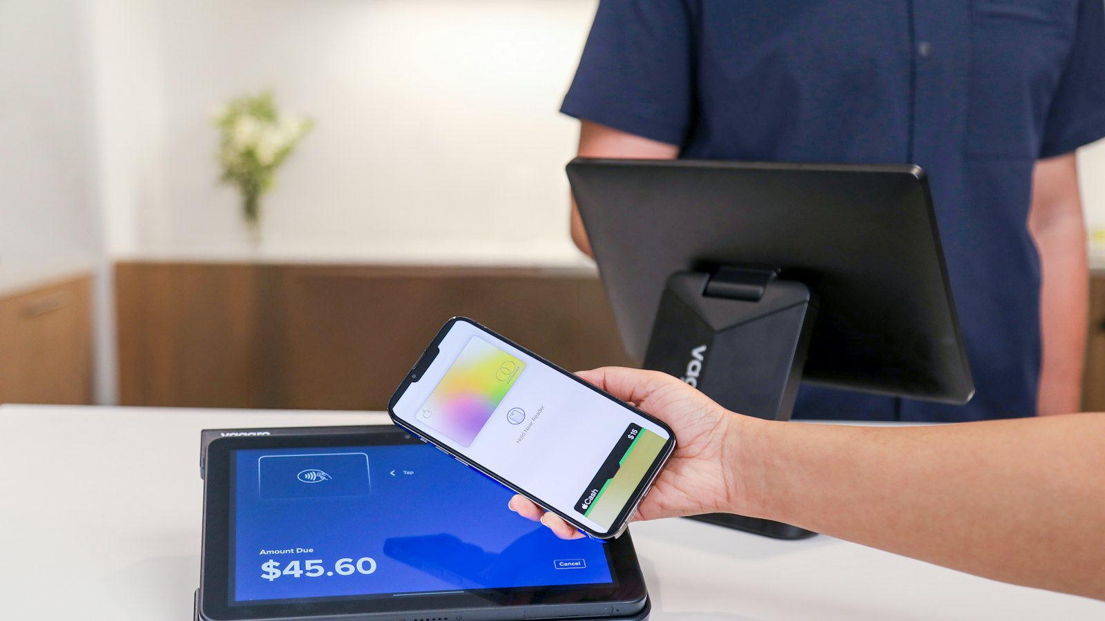 A phone being used to pay at a counter terminal
