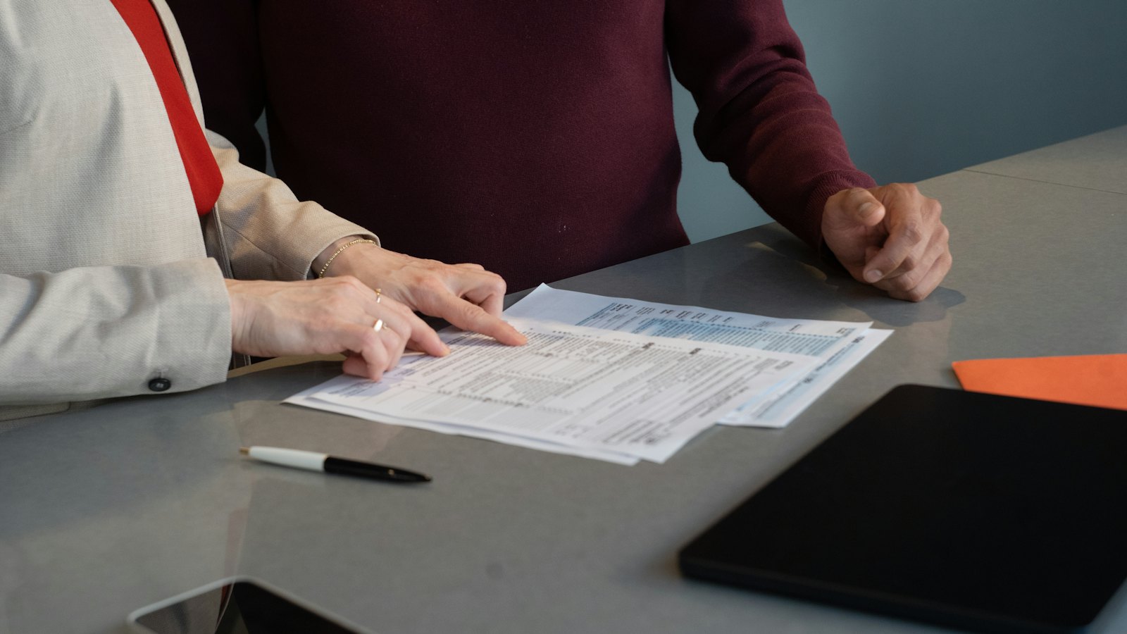 Two people reviewing documents at a table
