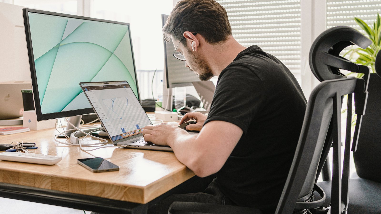 A man sitting at a desk looking at his computer