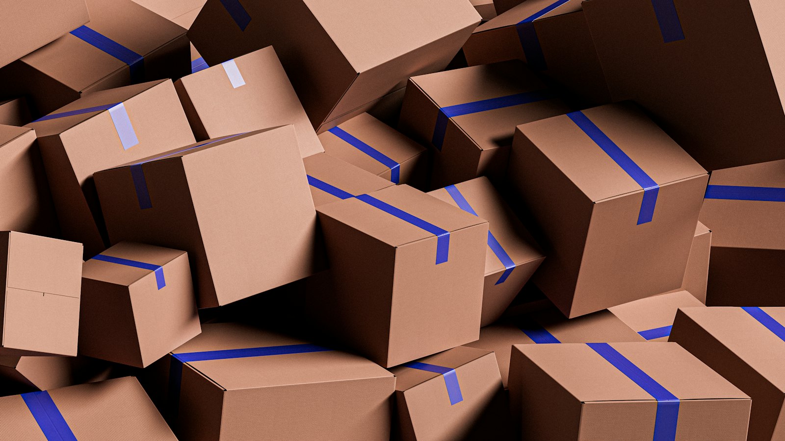 A pile of cardboard boxes sealed with blue tape