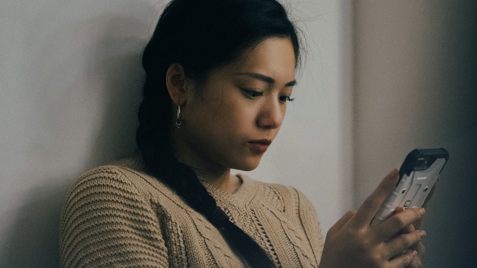 A woman reading a message on her phone