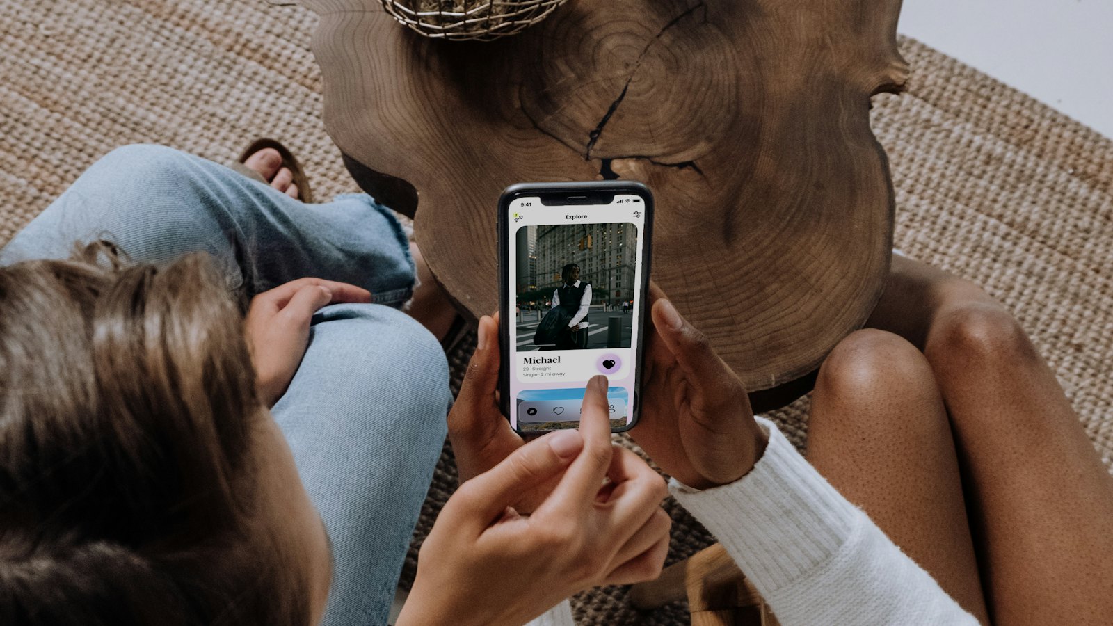 Two people sitting close together looking at a phone