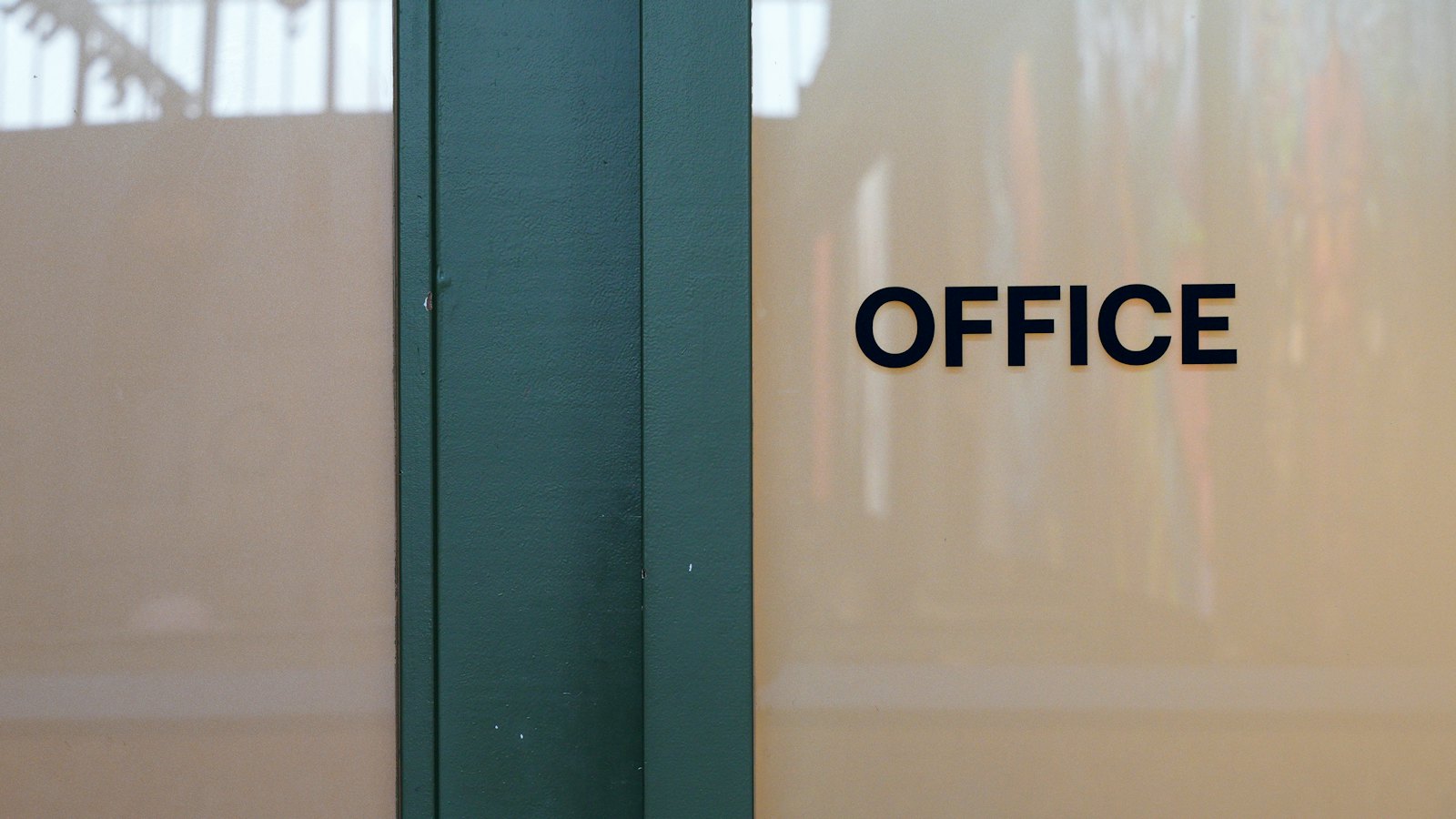 An office door with the word office on the wall