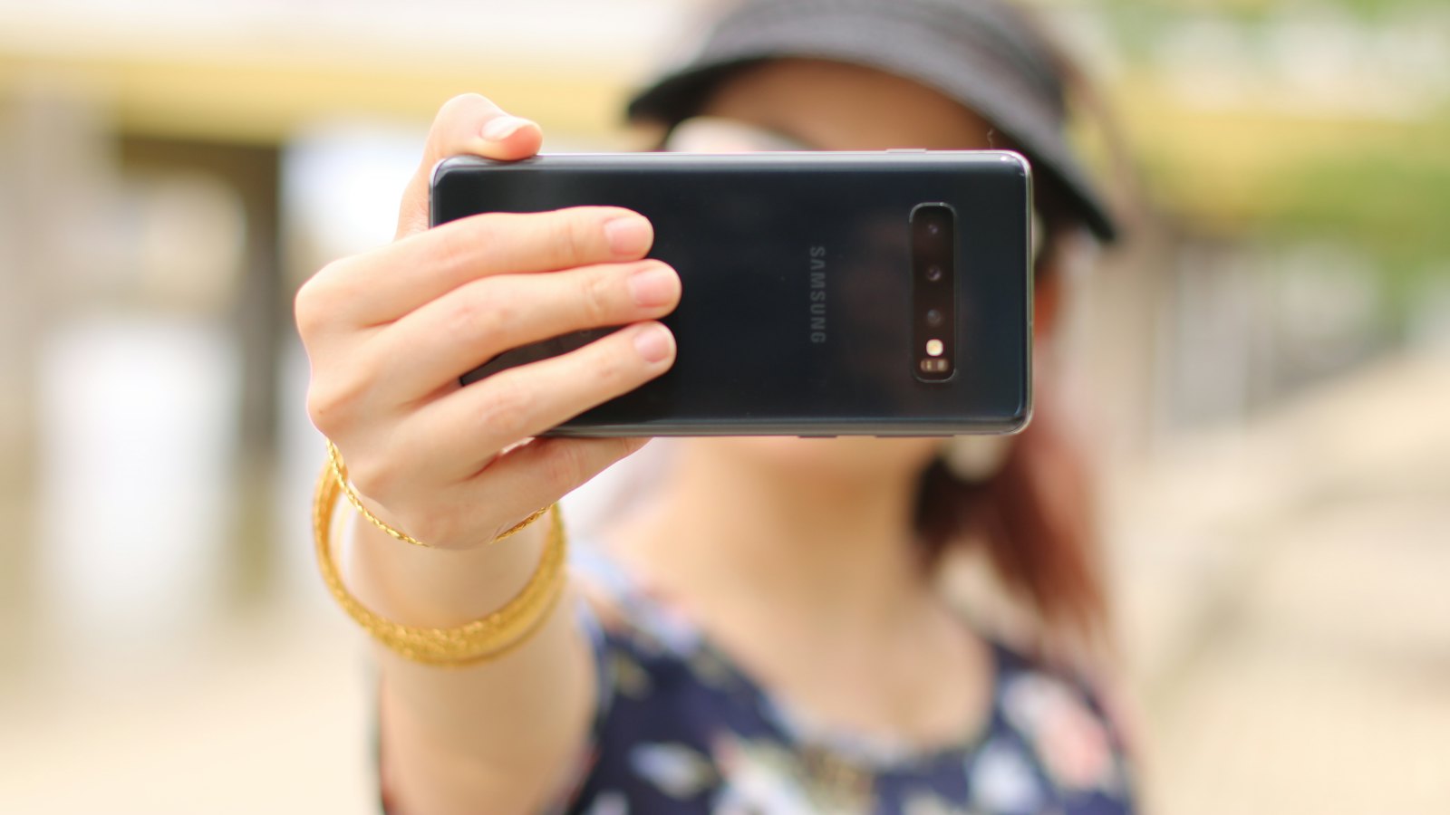 A woman holding up her phone camera towards the viewer