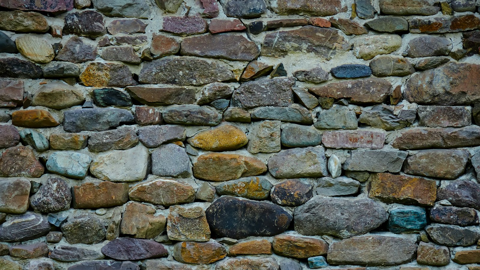 A stone wall built from many layers of rock