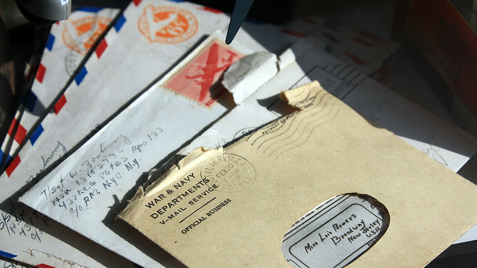 A pile of opened letters and envelopes