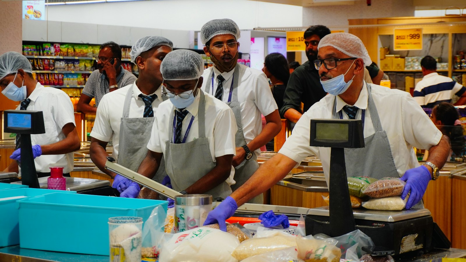 Supermarket staff at a service counter