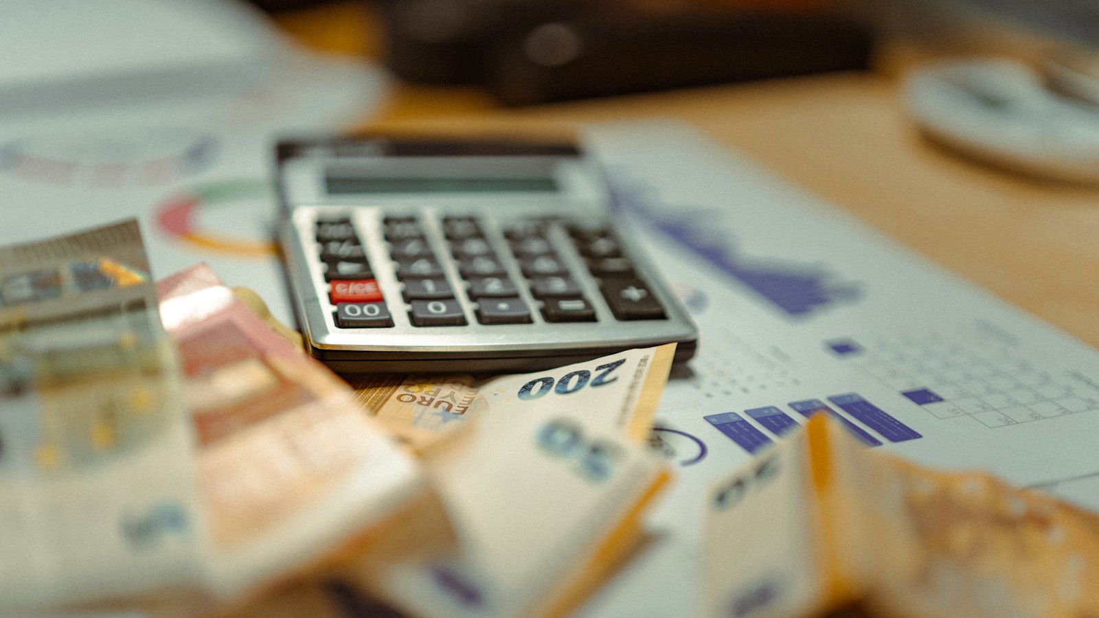 Banknotes and a calculator on a desk
