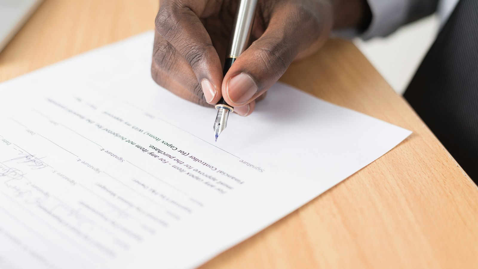 A hand writing on a sheet of paper