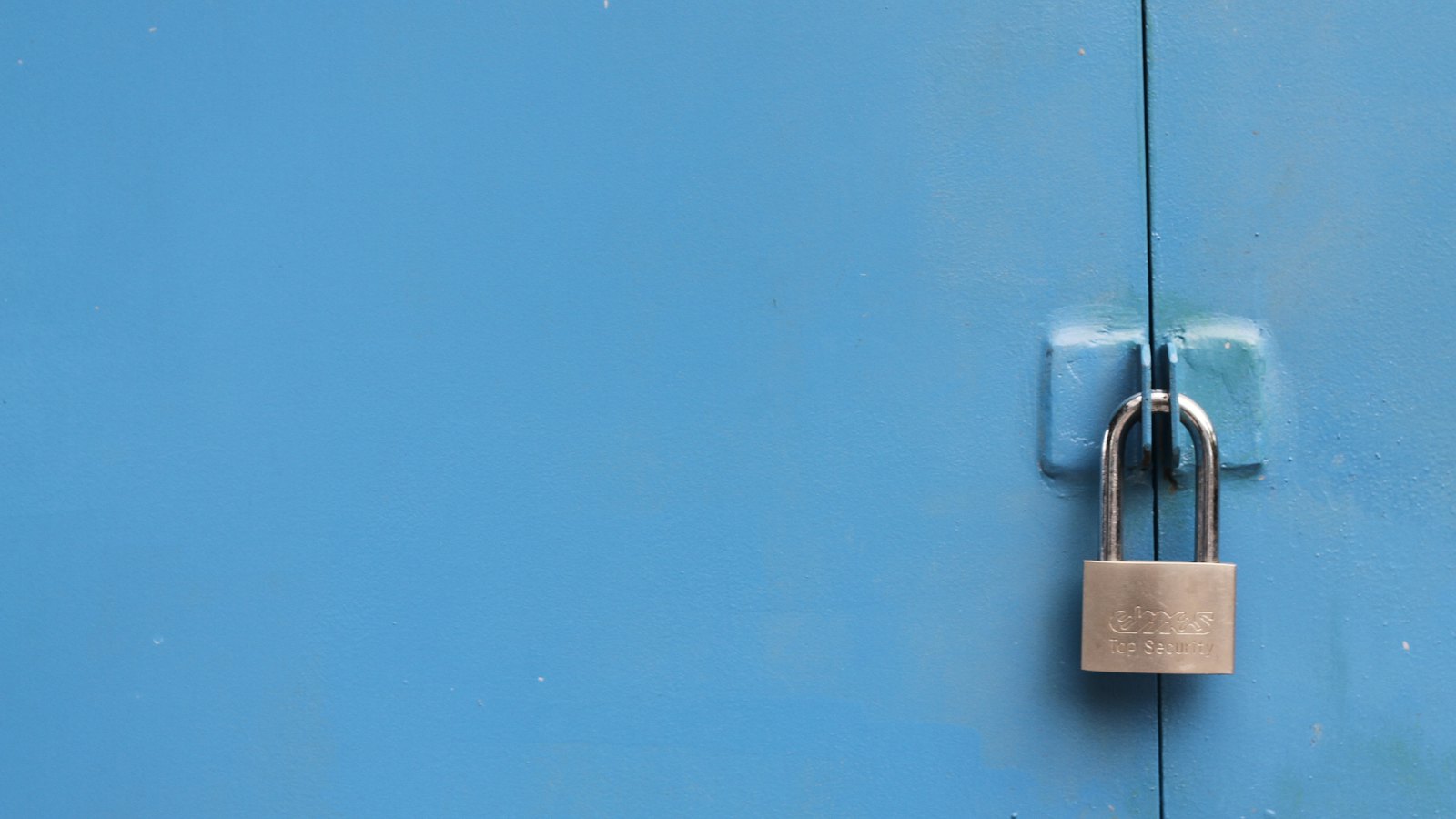 A padlock on a blue door