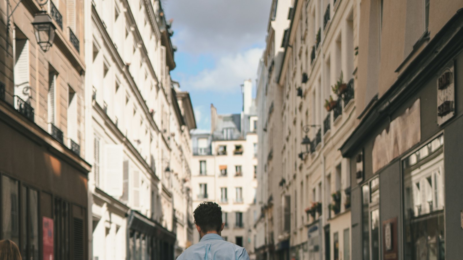 A man carrying a parcel down a city street