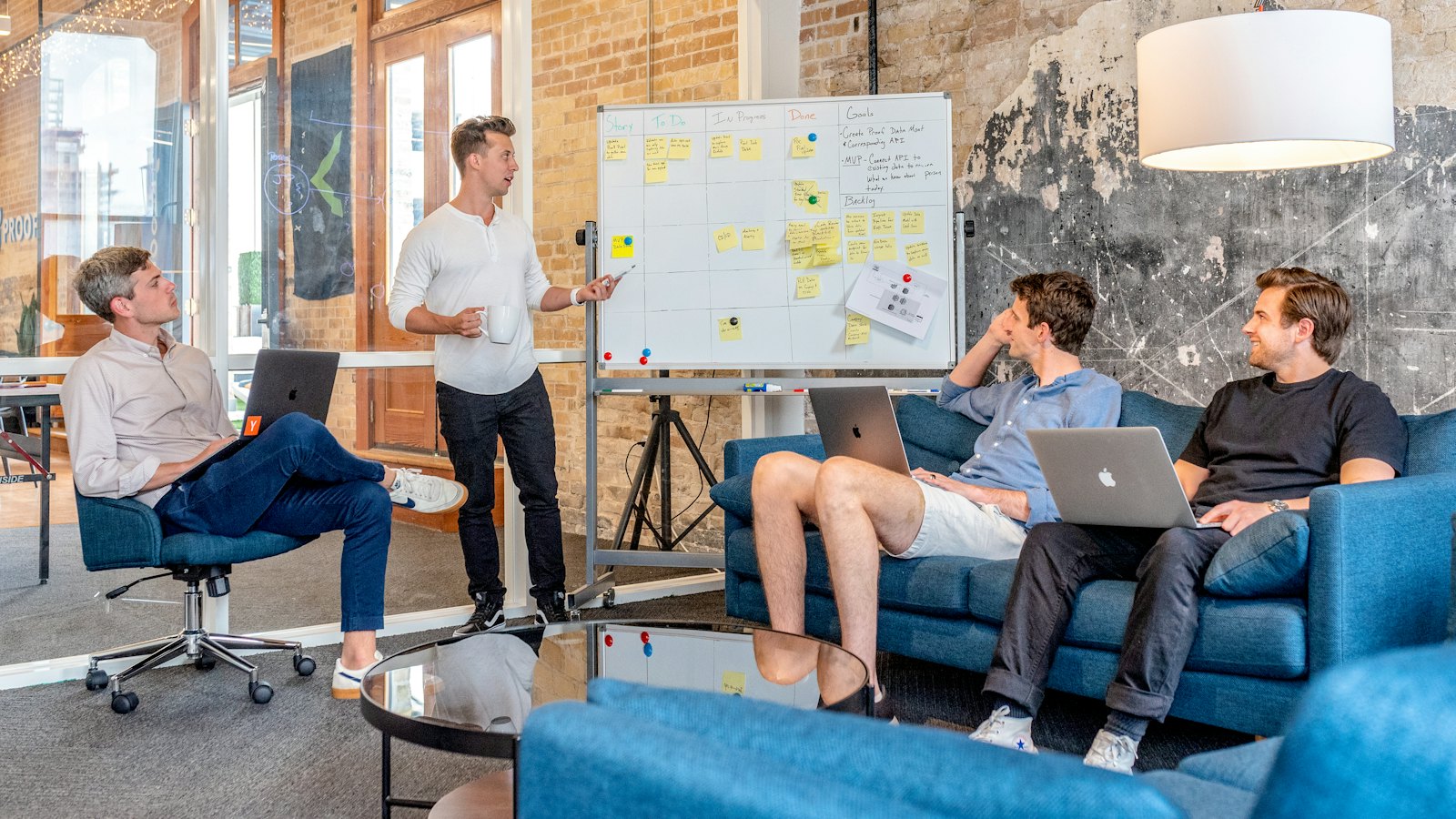 A team meeting around a whiteboard