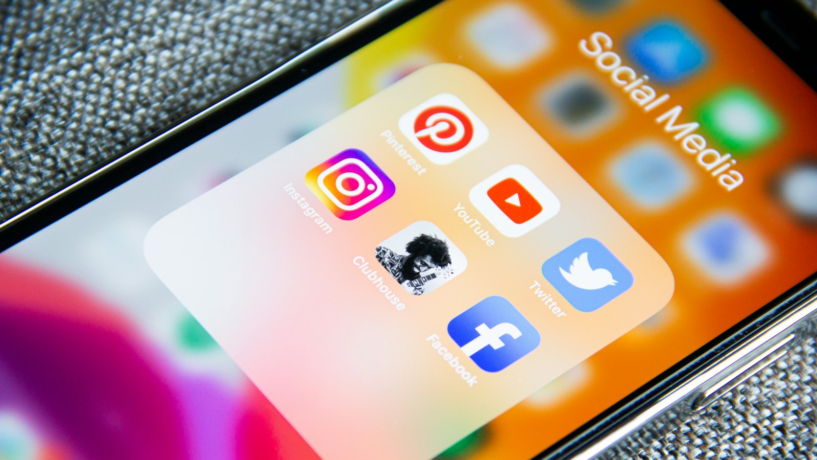 A phone showing a folder of social media apps