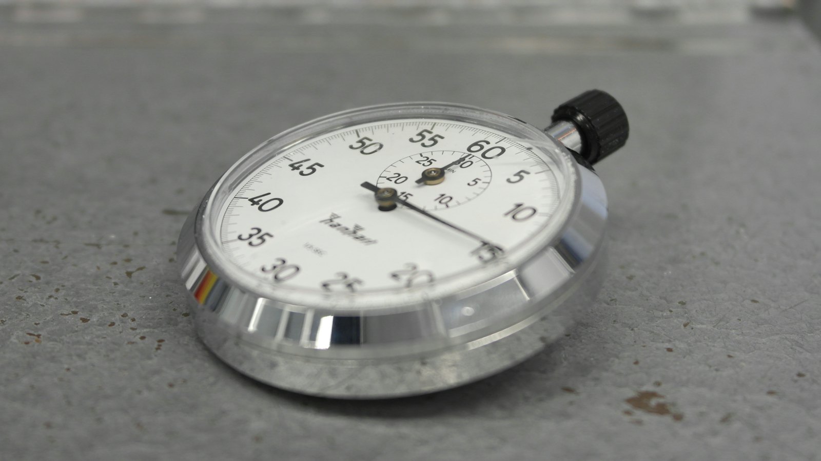 A stopwatch on a grey surface