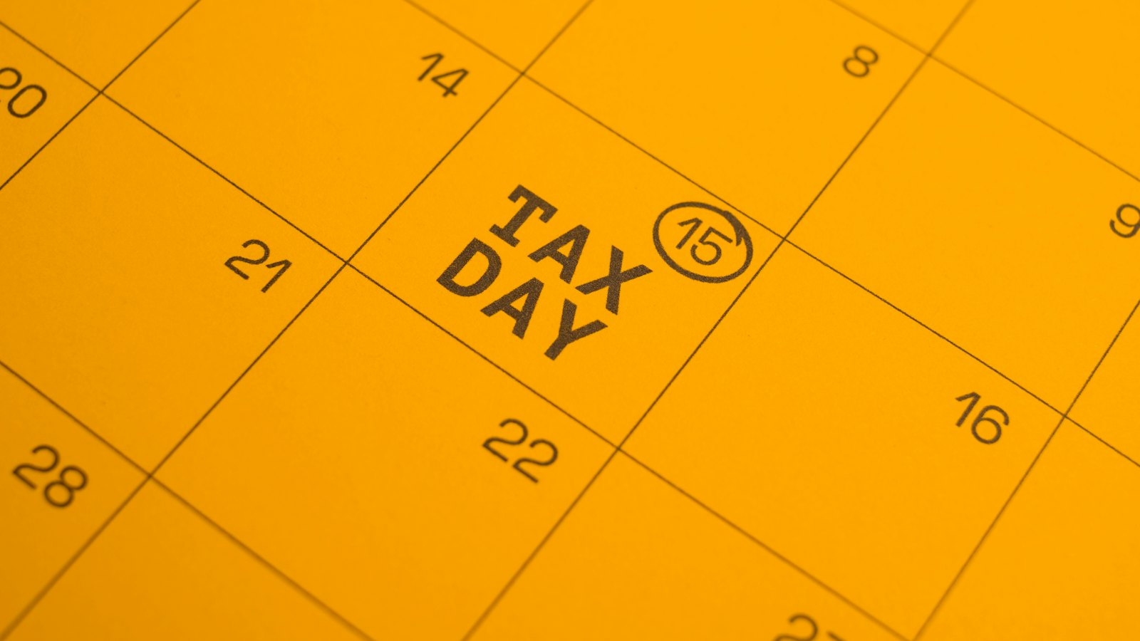 A yellow calendar with tax day circled