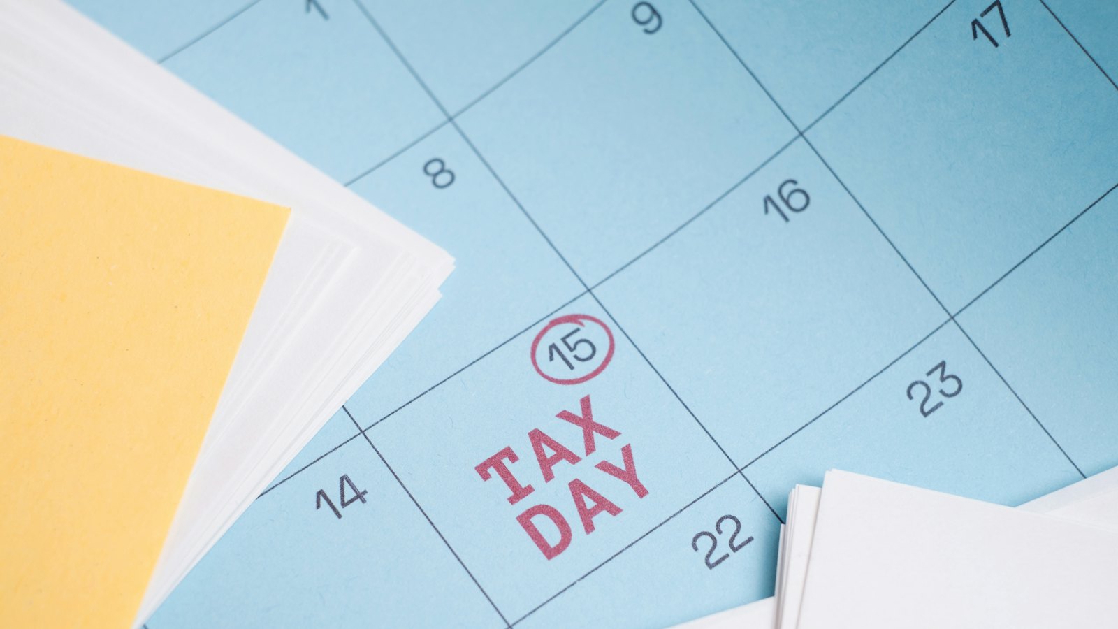 A calendar with the words tax day circled in red
