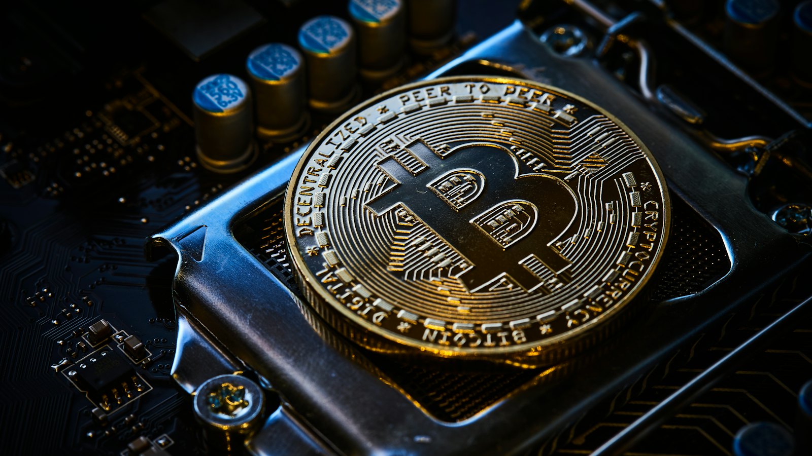 A bitcoin coin on a computer circuit board
