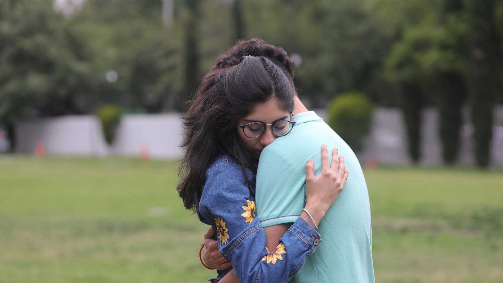 Two people embracing in a park