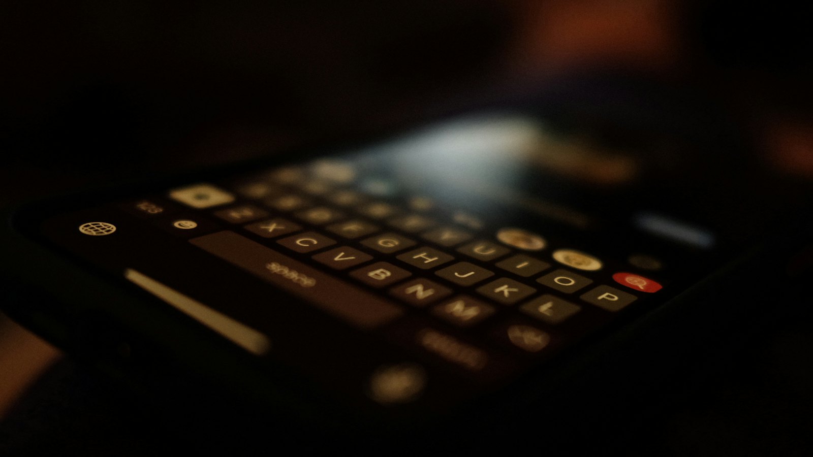 A phone keypad glowing faintly in a dark room