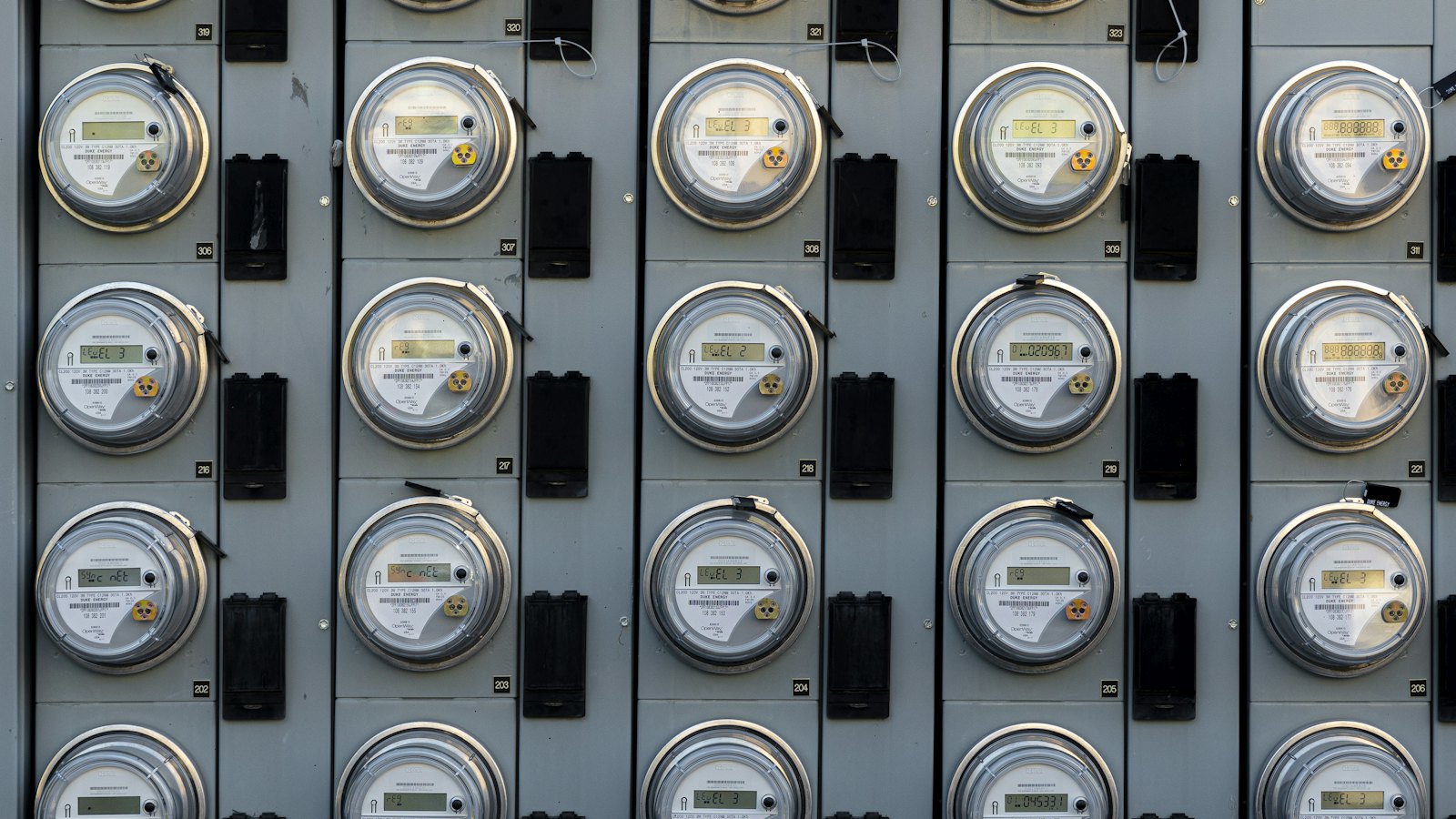 Rows of electricity meters mounted on a wall