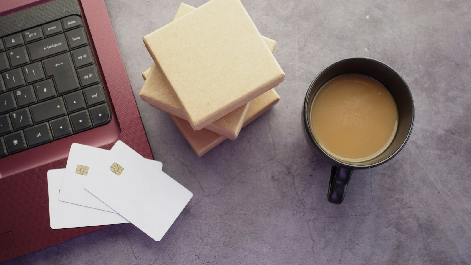 Blank cards beside a laptop and a cup of coffee