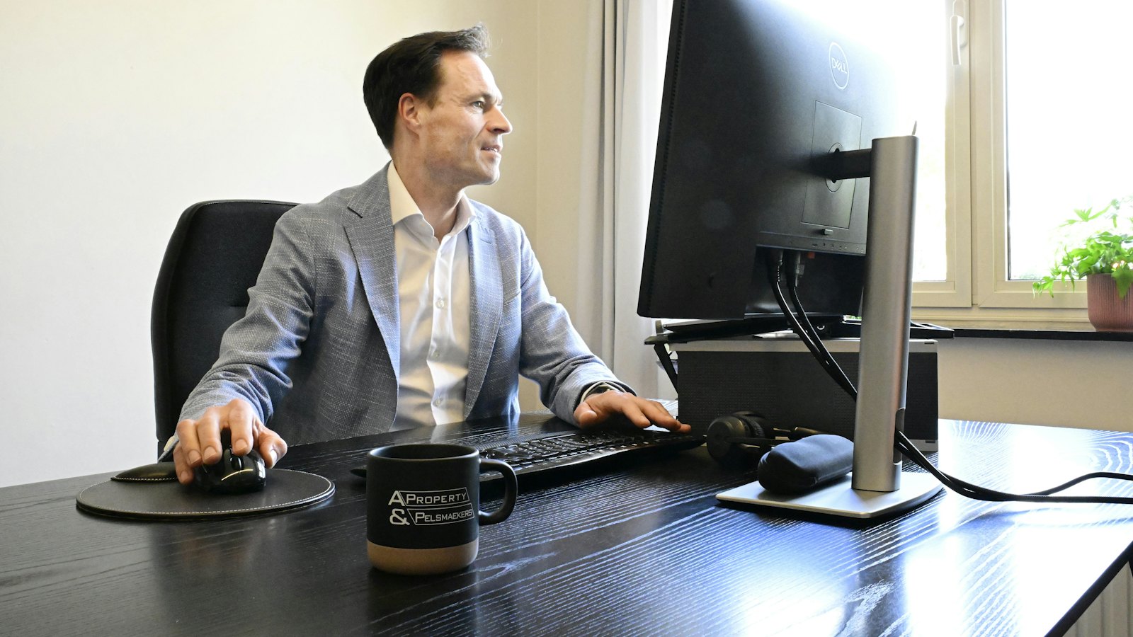 An executive working at a desktop computer in an office