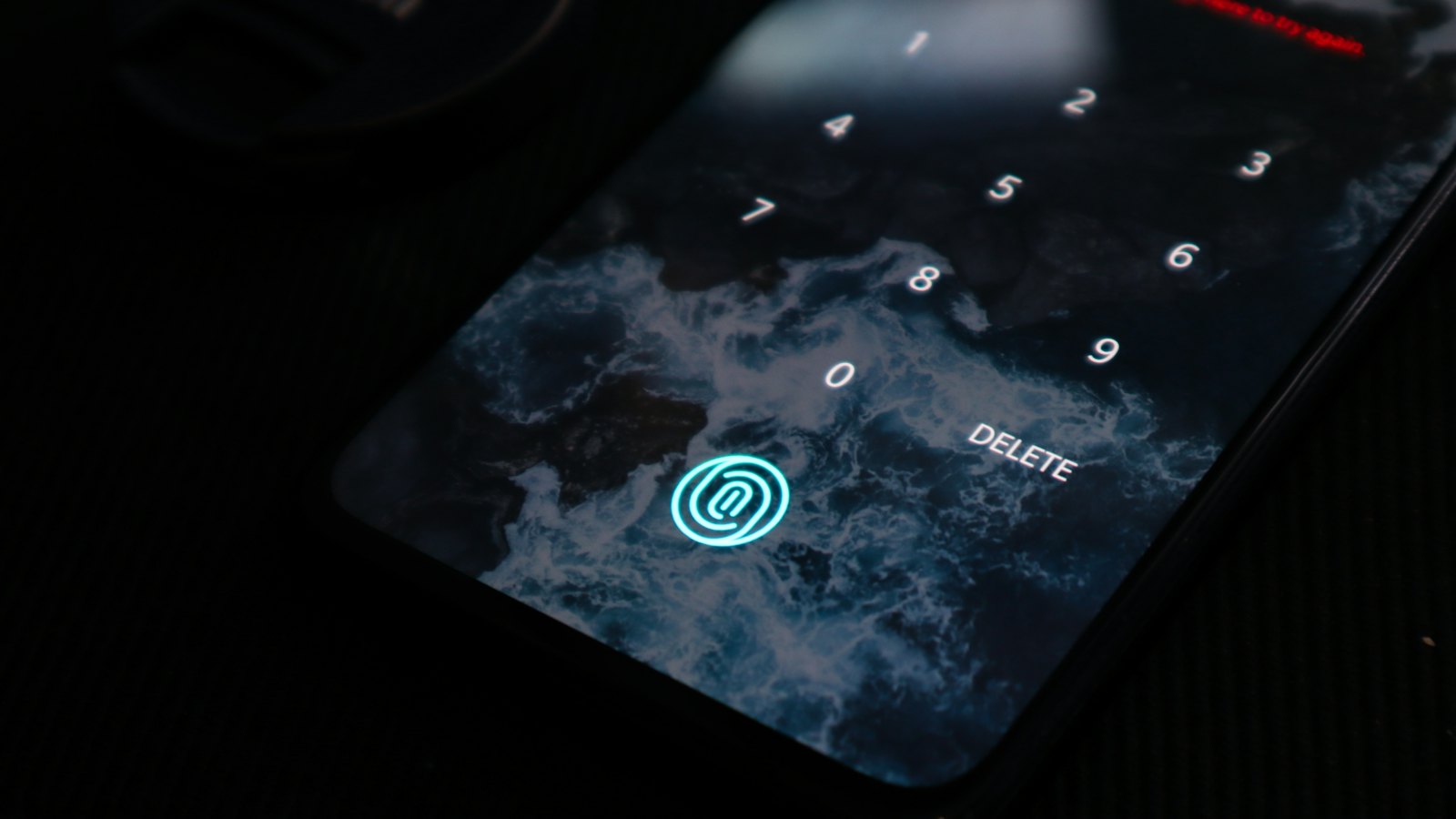 A phone screen with a glowing fingerprint sensor icon