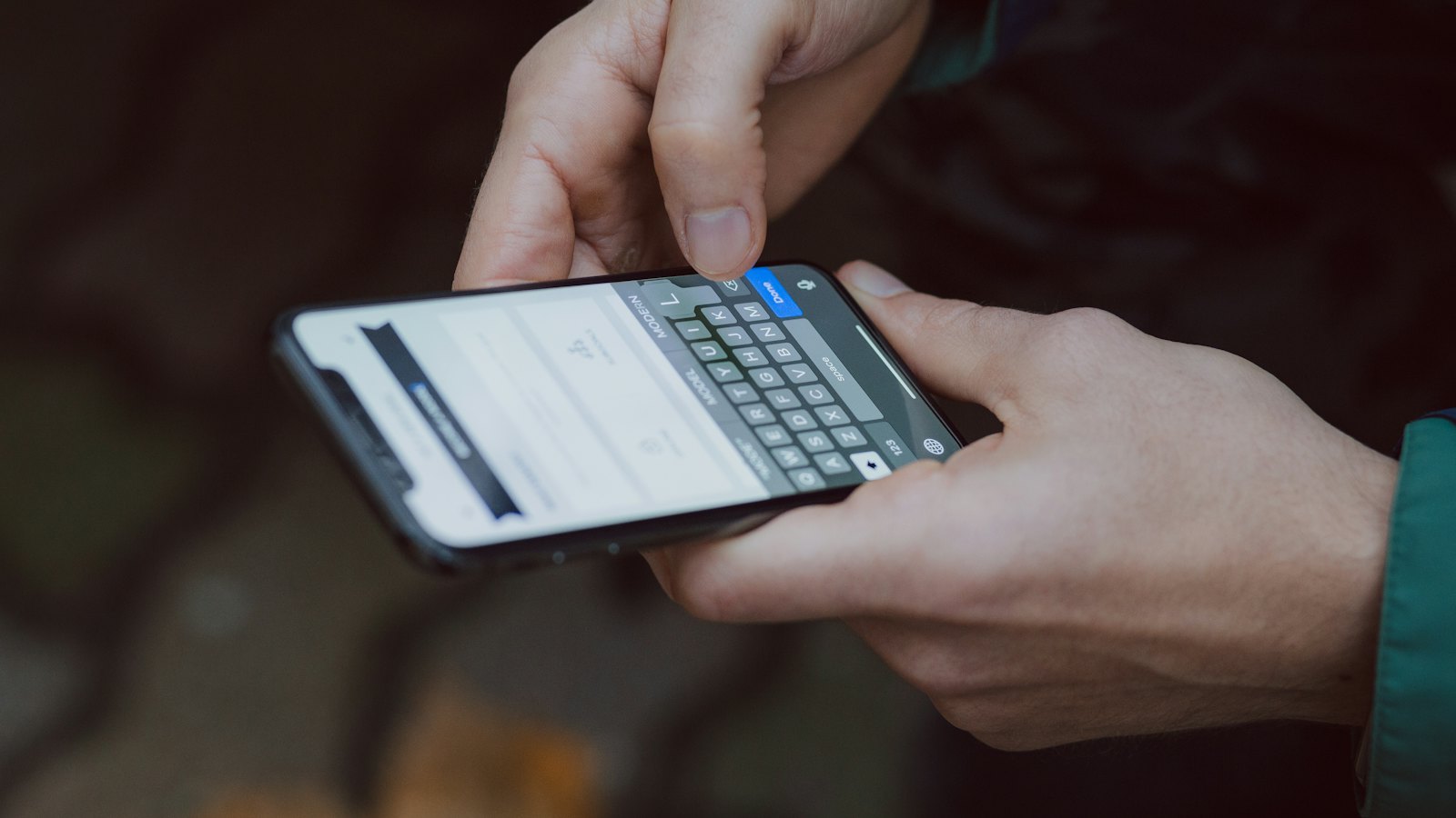 Two hands holding a smartphone and typing a message