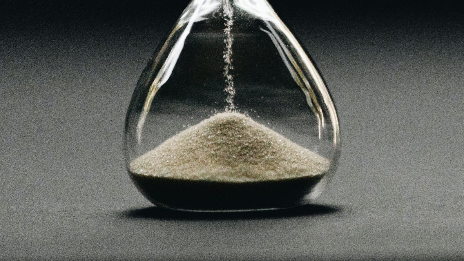 Sand running through an hourglass