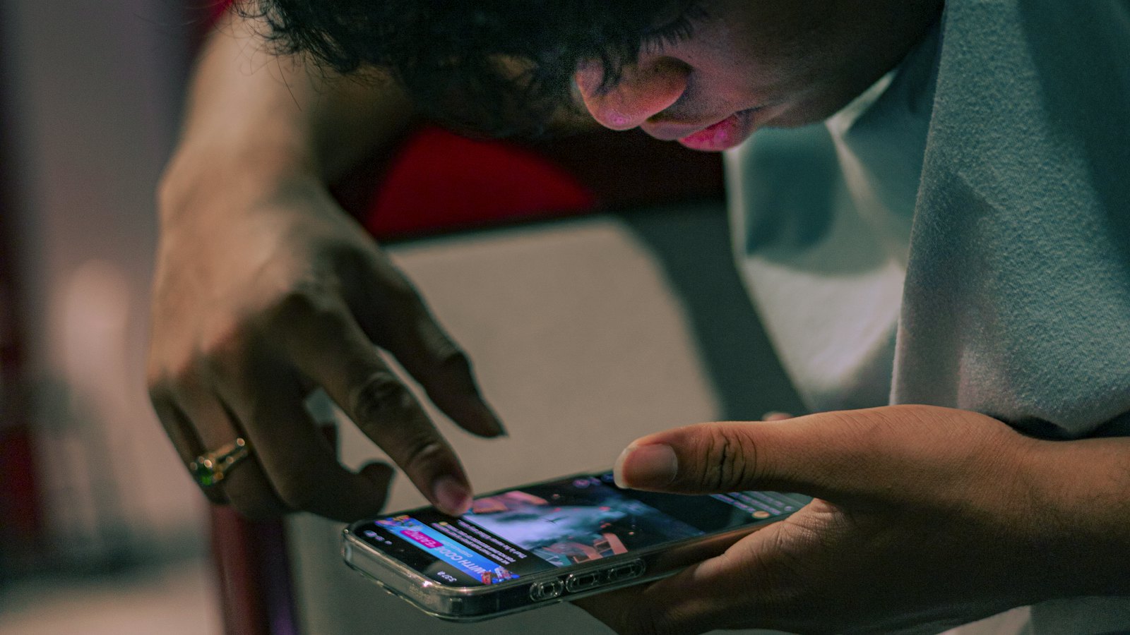 A distressed person sitting in low light